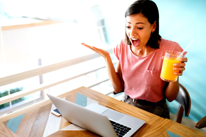 Confused shocked beautiful young woman looking at tablet computer